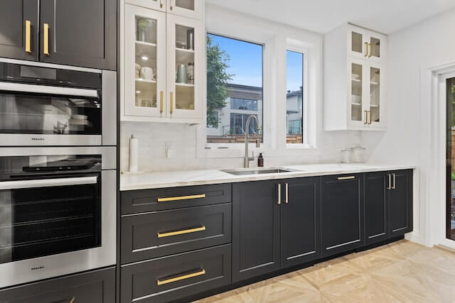 Monochrome Kitchen with Black White Cabinets and Wood Floor